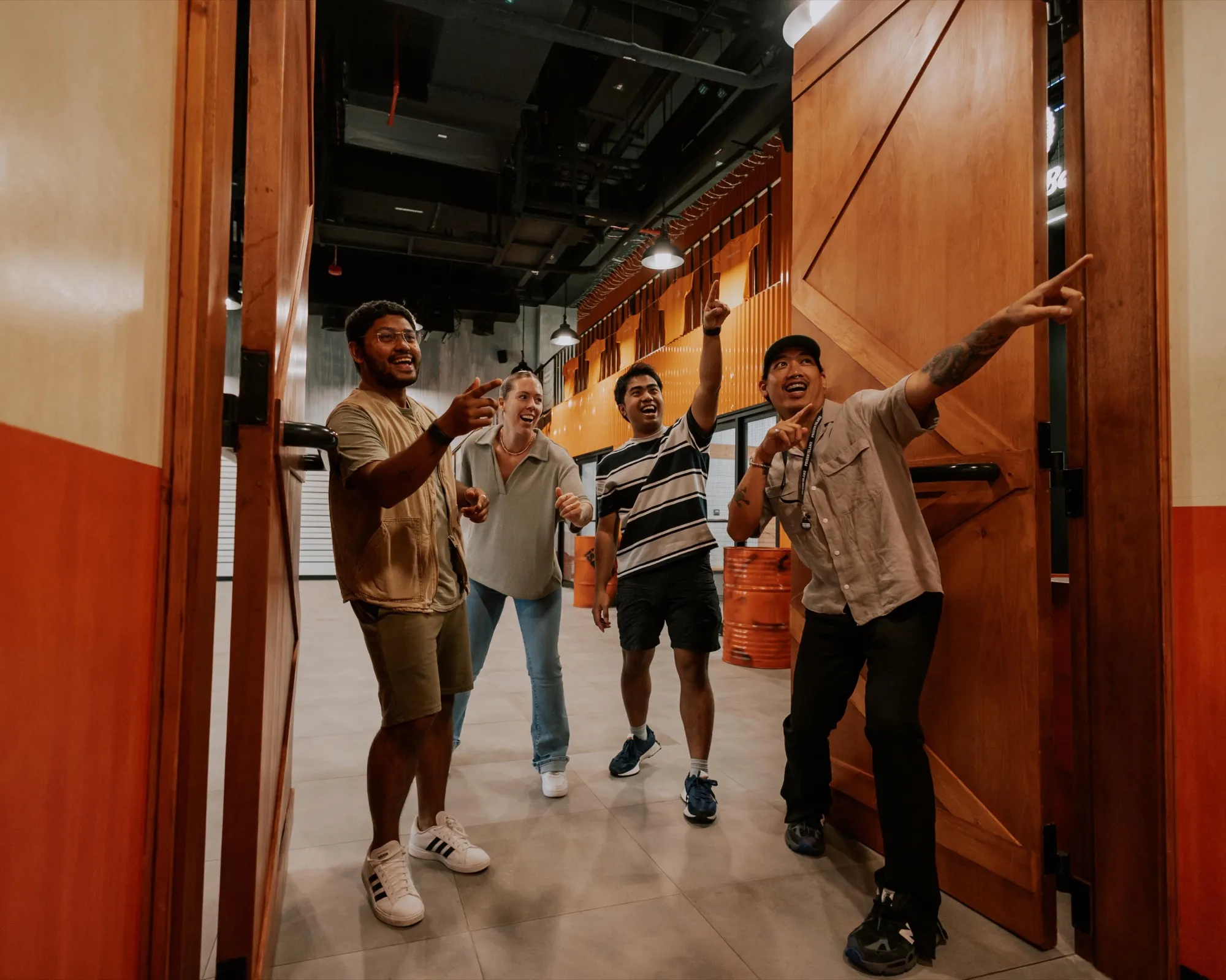 Group of friends cheering as they walk through the prison doors at Prison Island Riyadh